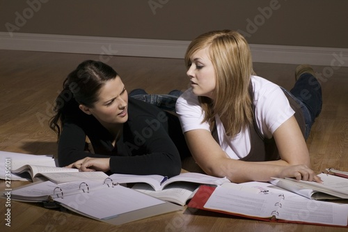 Photo: Two Women Studying On The Floor Two Women Studying On The Floor