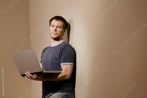 Photo: Man Holding Laptop Man Holding Laptop