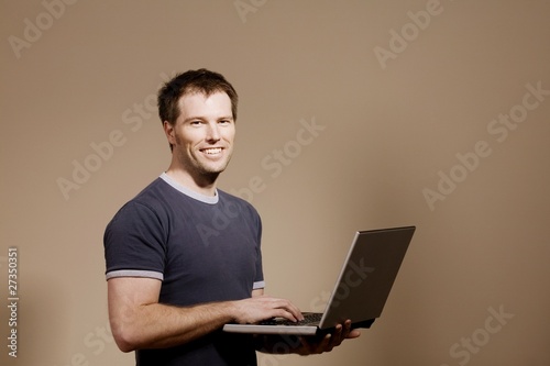 Photo: Man Holding Laptop Man Holding Laptop