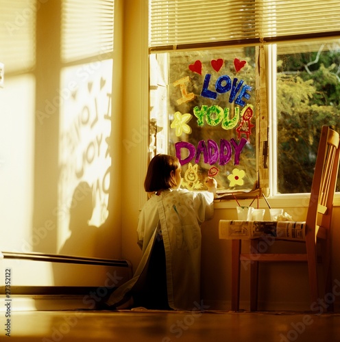 Photo: Girl Painting The Window With "I Love You Daddy" Girl Painting The Window With "I Love You Daddy"