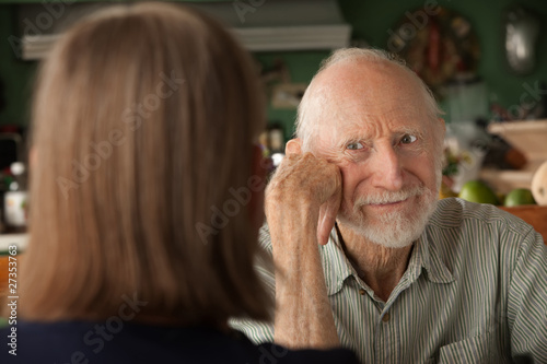 Photo: Senior couple at home focusing on angry man Senior couple at home focusing on angry man