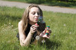 girl blowing soap bubbles lying on green grass dandelions girl blowing soap bubbles lying on green grass dandelions