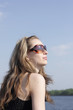 The young girl in sunglasses against the sky The young girl in sunglasses against the sky