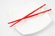 White plate with red chopsticks White plate with red chopsticks
