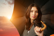 Female with black umbrella on beautiful sunset background