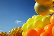 Inflatable yellow helium balloons on blue sky background Inflatable yellow helium balloons on blue sky background