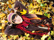Girl in autumn leaves.