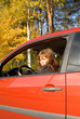 The girl sitting in the red car