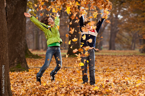 Photo: Kids jumping in autumn park Kids jumping in autumn park