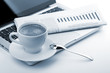 Cappuccino cup with laptop and newspaper Cappuccino cup with laptop and newspaper
