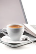 Hot cappuccino cup on laptop and newspaper Hot cappuccino cup on laptop and newspaper