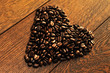 heart made of coffee beans on a wooden floor heart made of coffee beans on a wooden floor
