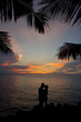 romantic silhouette couple kissing in the sunset