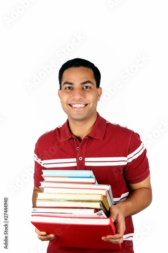 Photo: Young male student holding books. Young male student holding books.