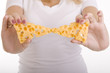 Two triangular slices of cheese in the hands of a girl