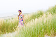 Model girl walking in sand dunes beach