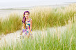 Model girl walking in sand dunes beach