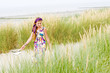 Model girl walking in sand dunes beach