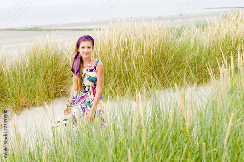 Photo: Model girl walking in sand dunes beach Model girl walking in sand dunes beach