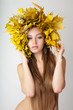 At the woman an autumn wreath on a head.