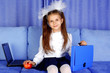Schoolgirl with laptop, case and red apple in sofa Schoolgirl with laptop, case and red apple in sofa