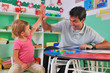 Photo: preschool teacher and child giving high-five preschool teacher and child giving high-five