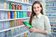 woman at pharmacy buying shampoo