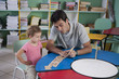 preschool teacher and child in the classroom