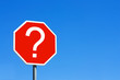 Red question mark sign against a blue sky Red question mark sign against a blue sky