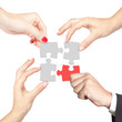 Photo: Teamwork solving a puzzle isolated on white Teamwork solving a puzzle isolated on white