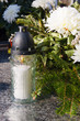 White candle and artificial flowers on a grave White candle and artificial flowers on a grave