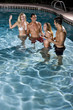Two couples in swimming pool at night Two couples in swimming pool at night