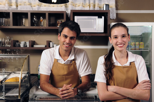 Photo: Waitress and waiter working at a cafe Waitress and waiter working at a cafe