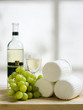 wooden plate of cheese grapes and wine wooden plate of cheese grapes and wine