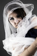 Portrait of a young girl wrapped in the white sheer scarf