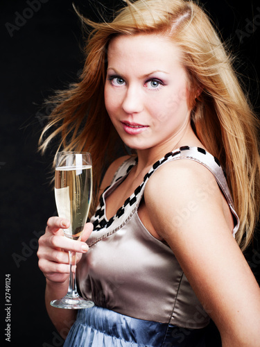 Photo: woman holding champagne over dark woman holding champagne over dark