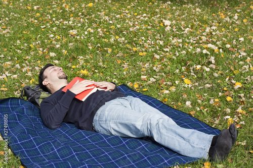 Photo: Young Adult Relaxing in the Park during a Weekend Afternoon Young Adult Relaxing in the Park during a Weekend Afternoon