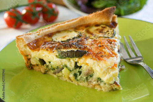 Photo: A sliced portion of Zucchini quiche on a plate A sliced portion of Zucchini quiche on a plate