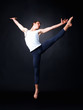 Male ballet dancer posing against black background - copyspace Male ballet dancer posing against black background - copyspace