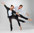 Two modern ballet dancers performing against white background