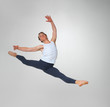 Ballet dancer practicing high jump against white background Ballet dancer practicing high jump against white background