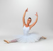 Young ballerina performing against white - copyspace