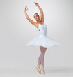 Pretty young ballerina performing against white - copyspace