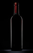 Red wine bottle silhouette over black background Red wine bottle silhouette over black background