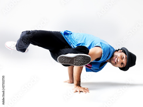 Photo: Street performer - Young male breakdancer performing bboying stu Street performer - Young male breakdancer performing bboying stu