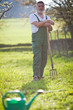 portrait of a senior man gardening in his garden