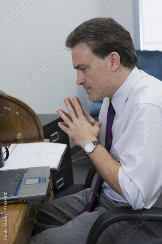 Photo: Businessman studying his records Businessman studying his records