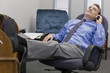 Businessman on the phone with feet in his desk