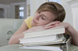 Photo: Teenage girl sleeping on her schoolbooks Teenage girl sleeping on her schoolbooks