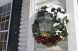 Christmas wreath on light fixture at home entrance